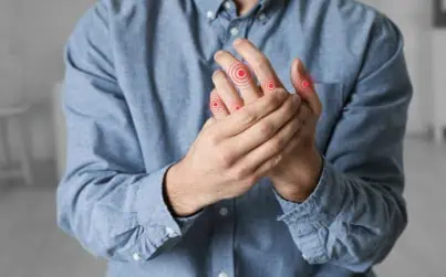 Person holding hand, pulsing with joint pain