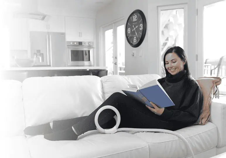 Woman on a couch using a PEMF device